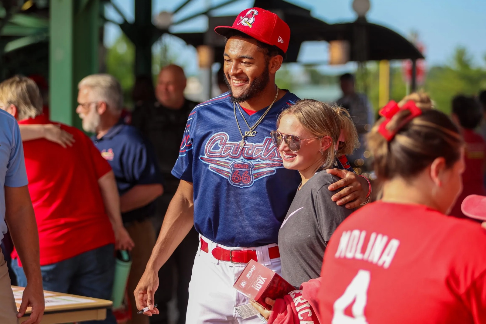 Springfield Cardinals outfielder Victor Scott II poses for a picture with a fan before a game at Hammons Field