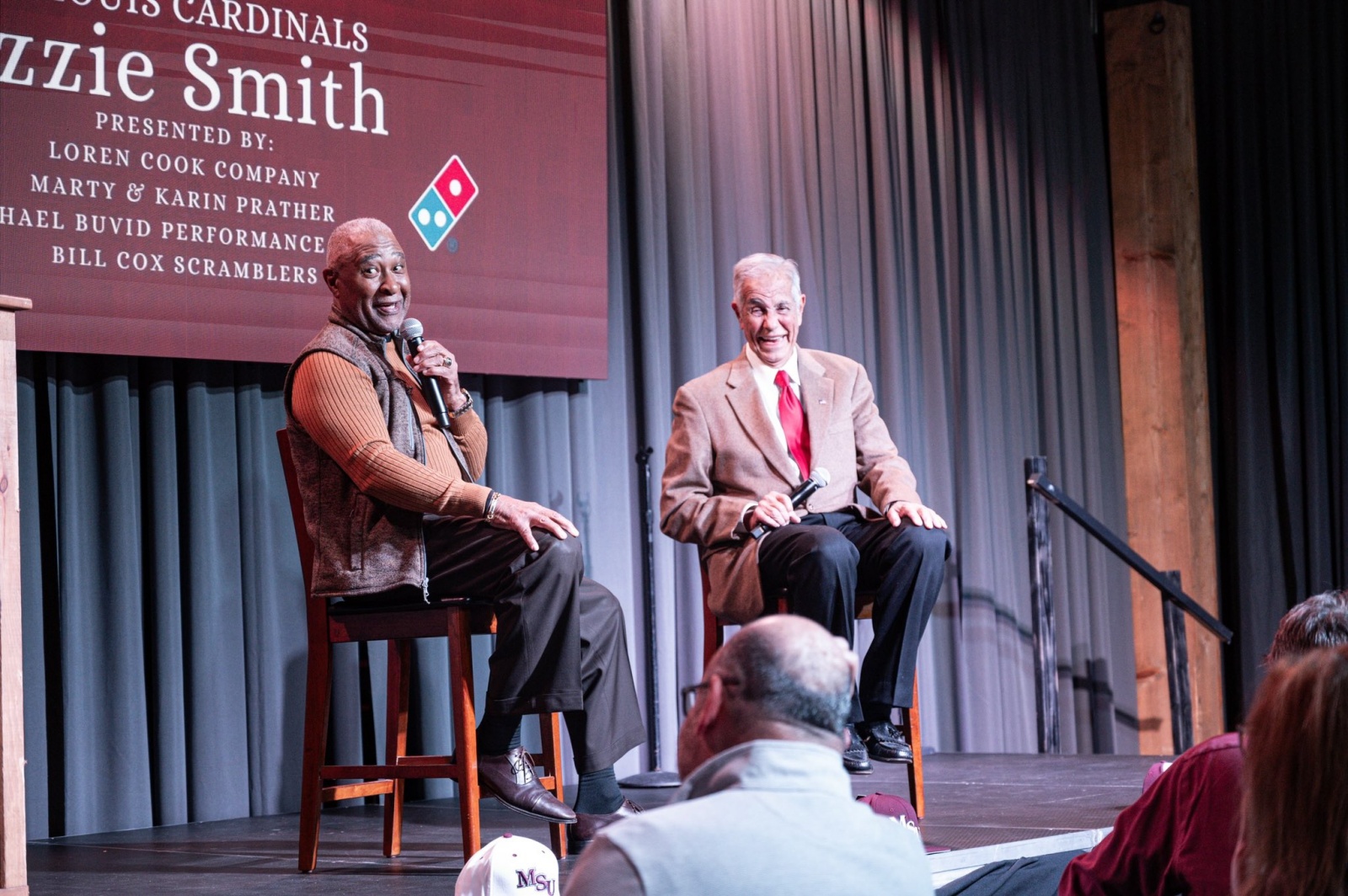 Ozzie Smith, left, and Ned Reynolds laugh while sitting on stage at Missouri State's Step Up to the Plate baseball fundraiser.