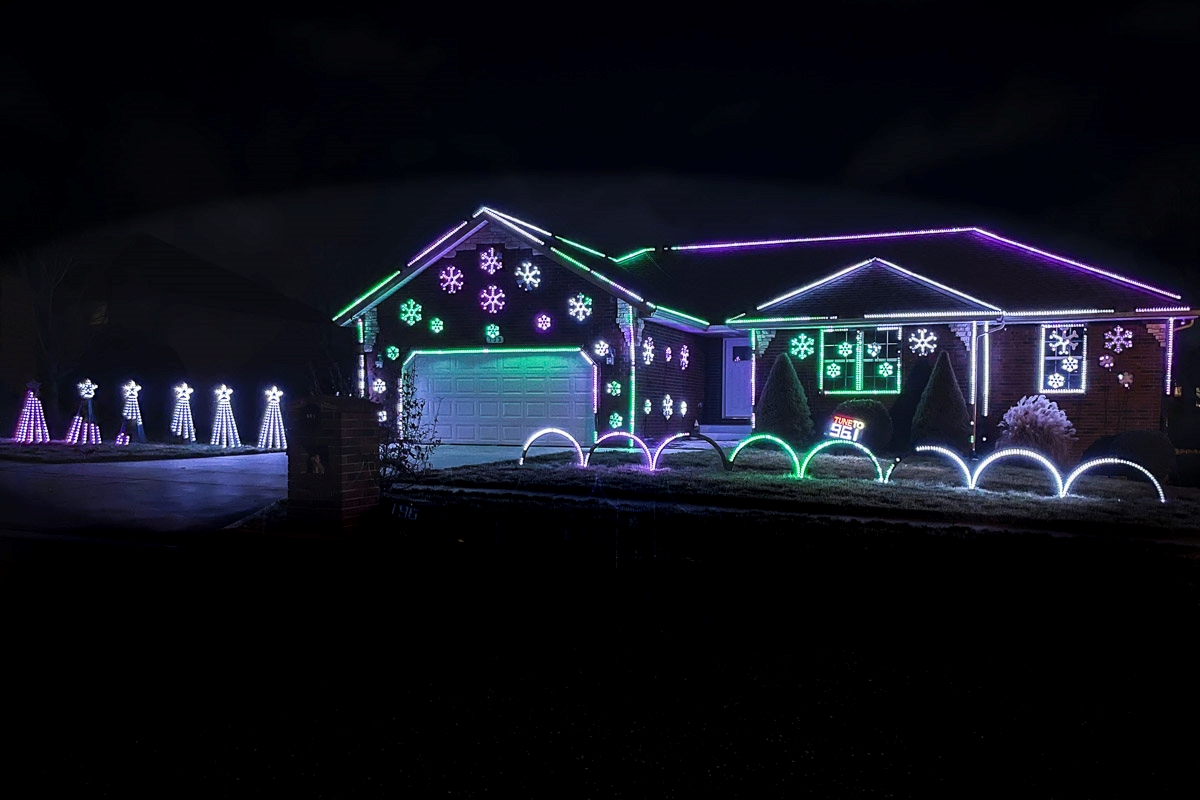 A Christmas light display in the front yard of a house