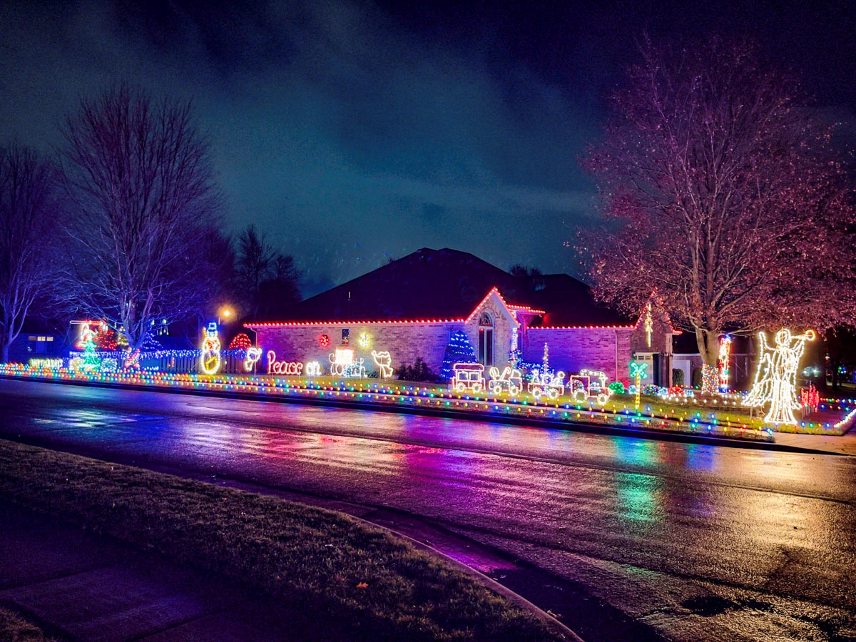 A Christmas light display in the front yard of a house