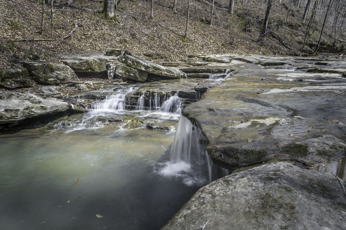 A low-shelf waterfall along Leatherwood Creek near the Buffalo National River is one of several pretty stops while hiking to Balanced Rock Falls. (Photo by Sony Hocklander)