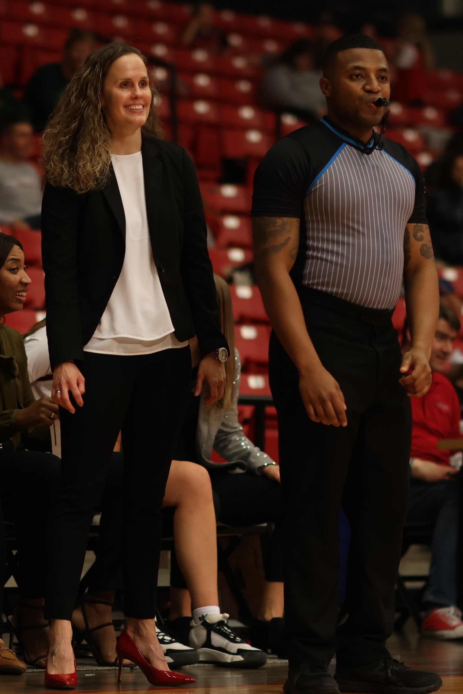 Drury women's basketball coach Kaci Bailey watches her team play during a game.