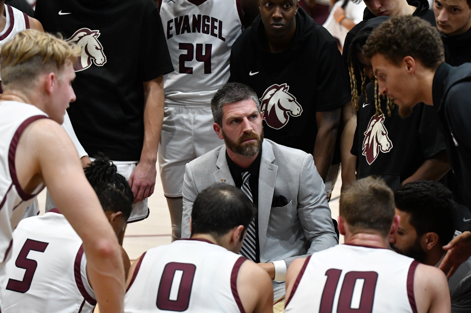 Evangel University men's basketball coach Bert Capel talks to his players during a game