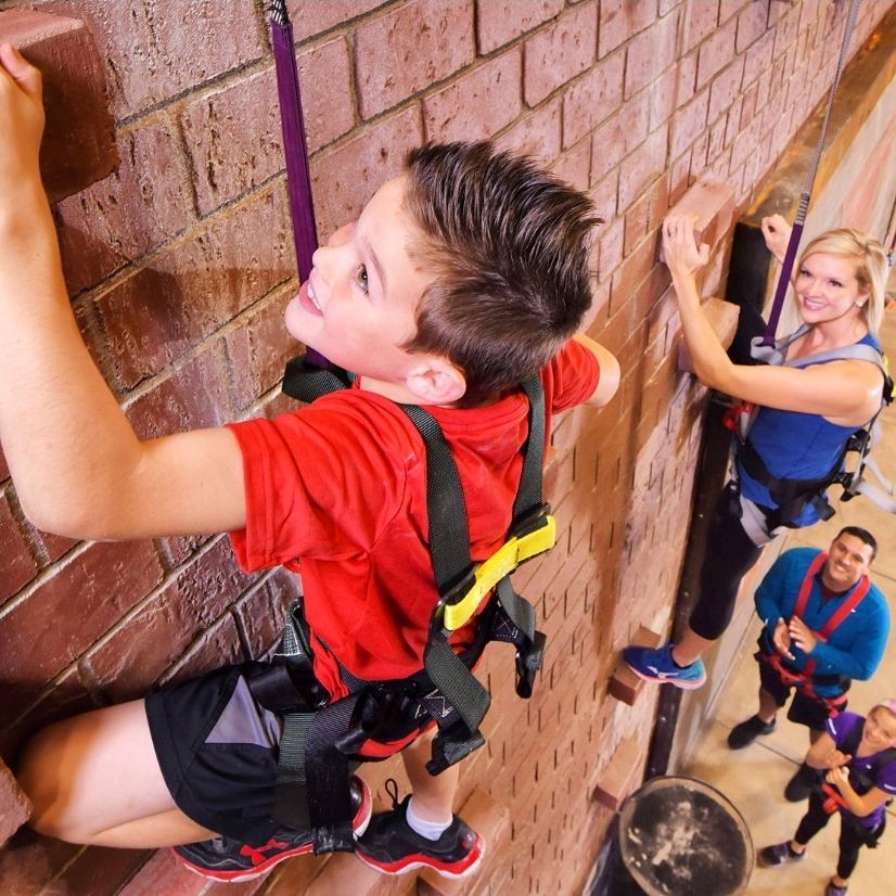 A young child on a rock climbing wall