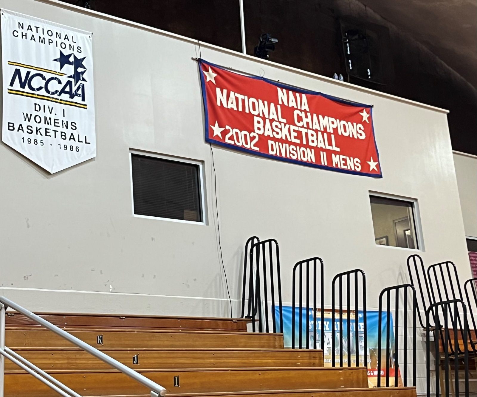 A red, white and blue banner hangs inside the Ashcroft Center. It reads "NAIA National Champions Basketball 2002 Division II Men's" (Photo by Lyndal Scranton)