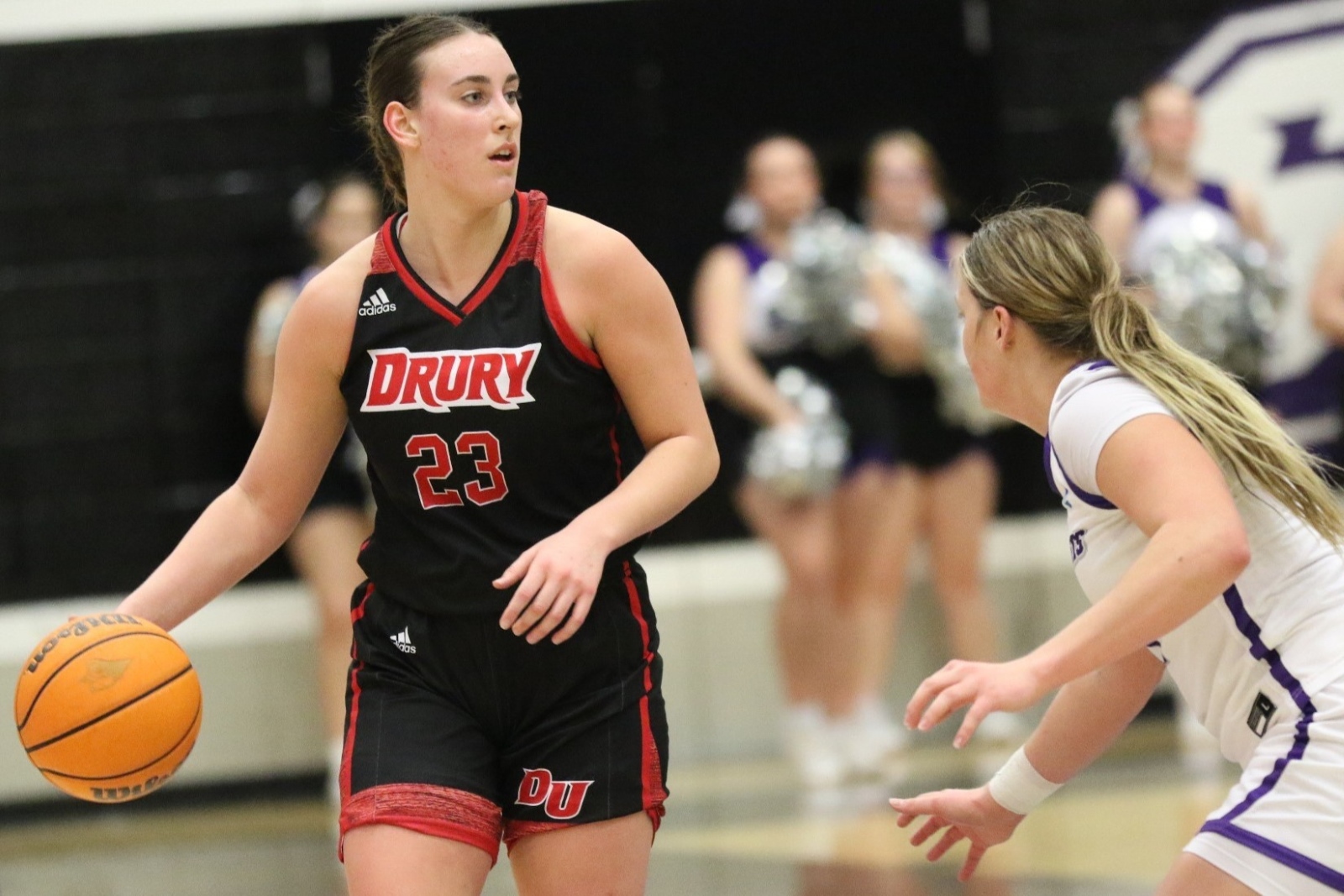 Reese Schaaf, wearing a Drury women's basketball uniform, dribbles the ball during a game.