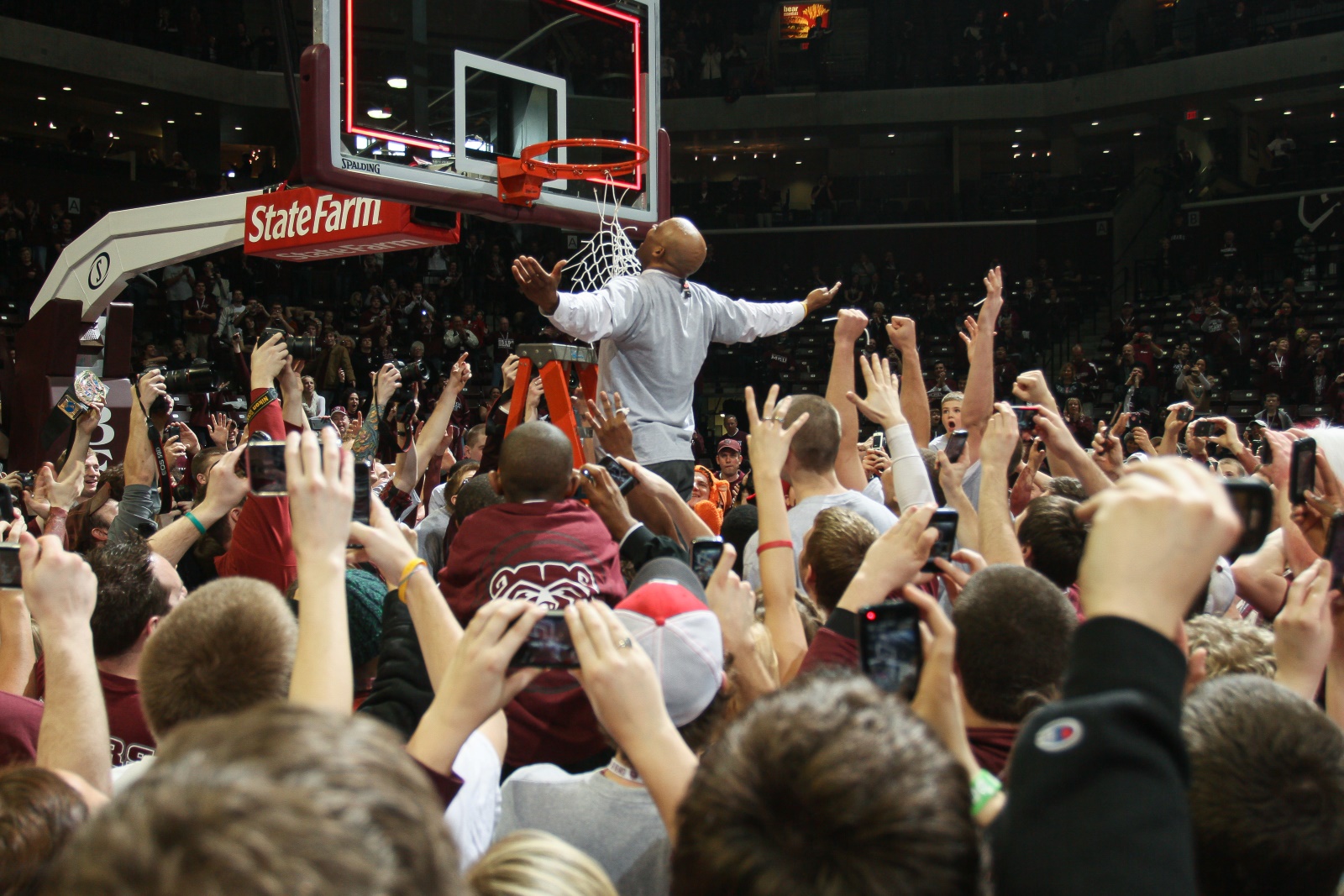 A crowd watches Cuonzo Martin cut the net off a basketball goal after Missouri State won the Missouri Valley Conference championship in 2011