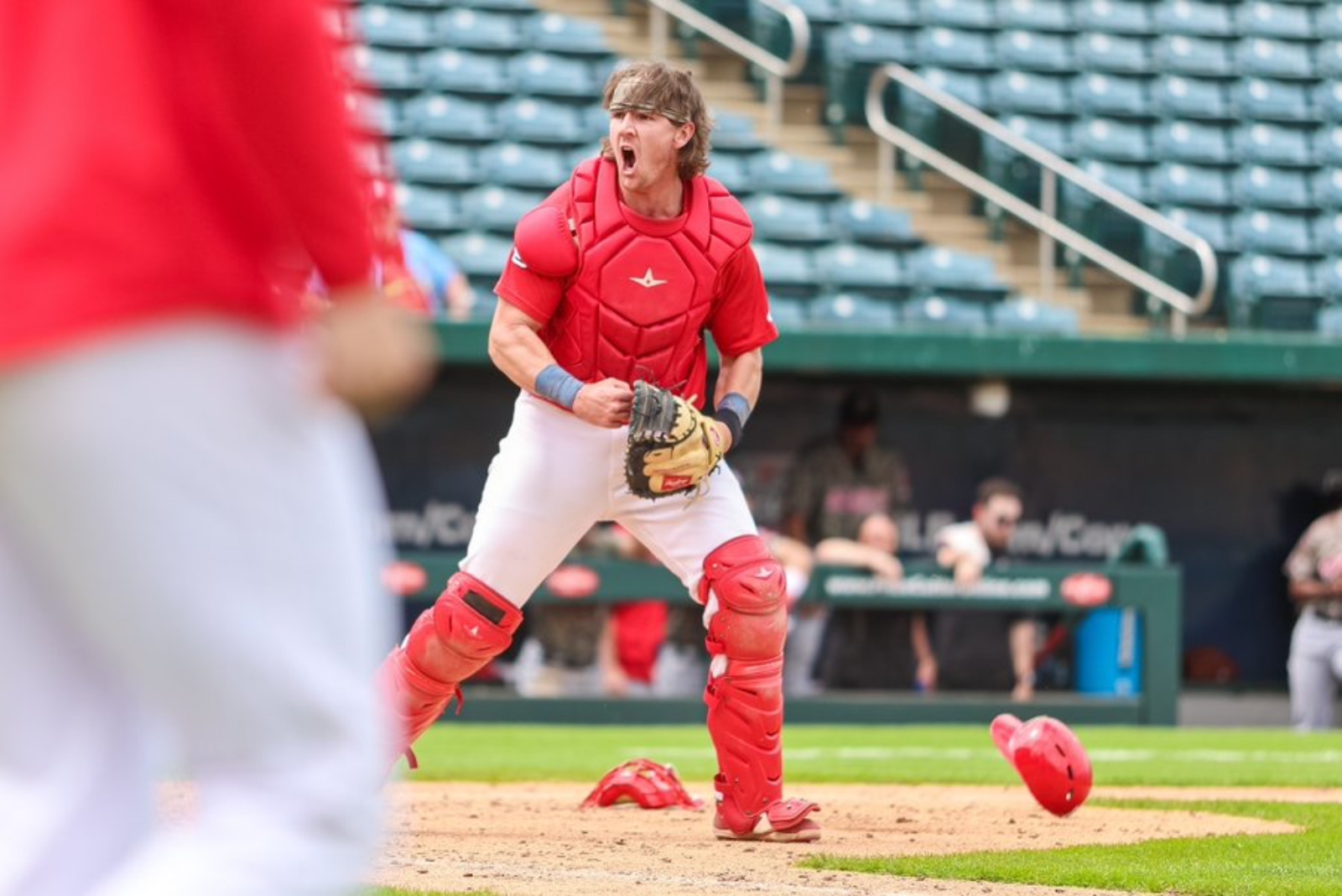 Wade Stauss, wearing catcher's gear and a Springfield Cardinals uniform, celebrates applying the tag for the final out of the Cardinals’ 7-6 victory over Arkansas on April 24 at Hammons Field.
