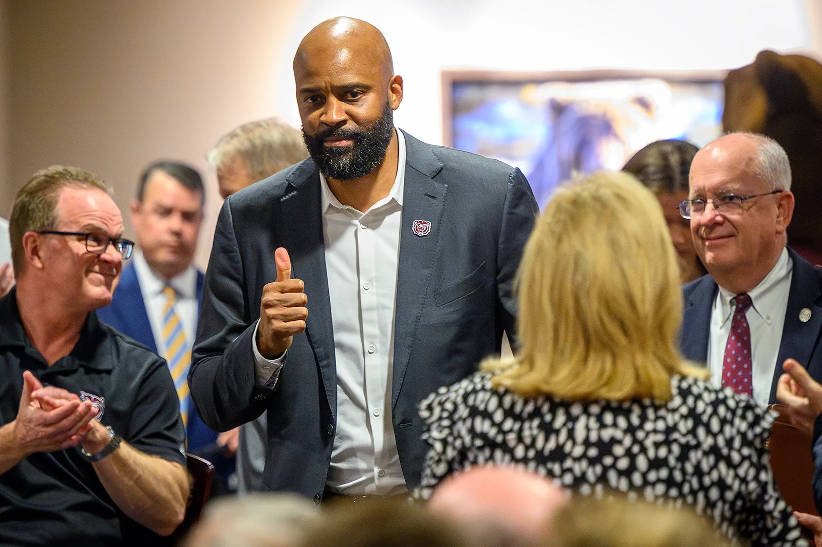 Cuonzo Martin gives a thumbs-up as he walks into the press conference announcing his hiring as Missouri State University's men's basketball coach.