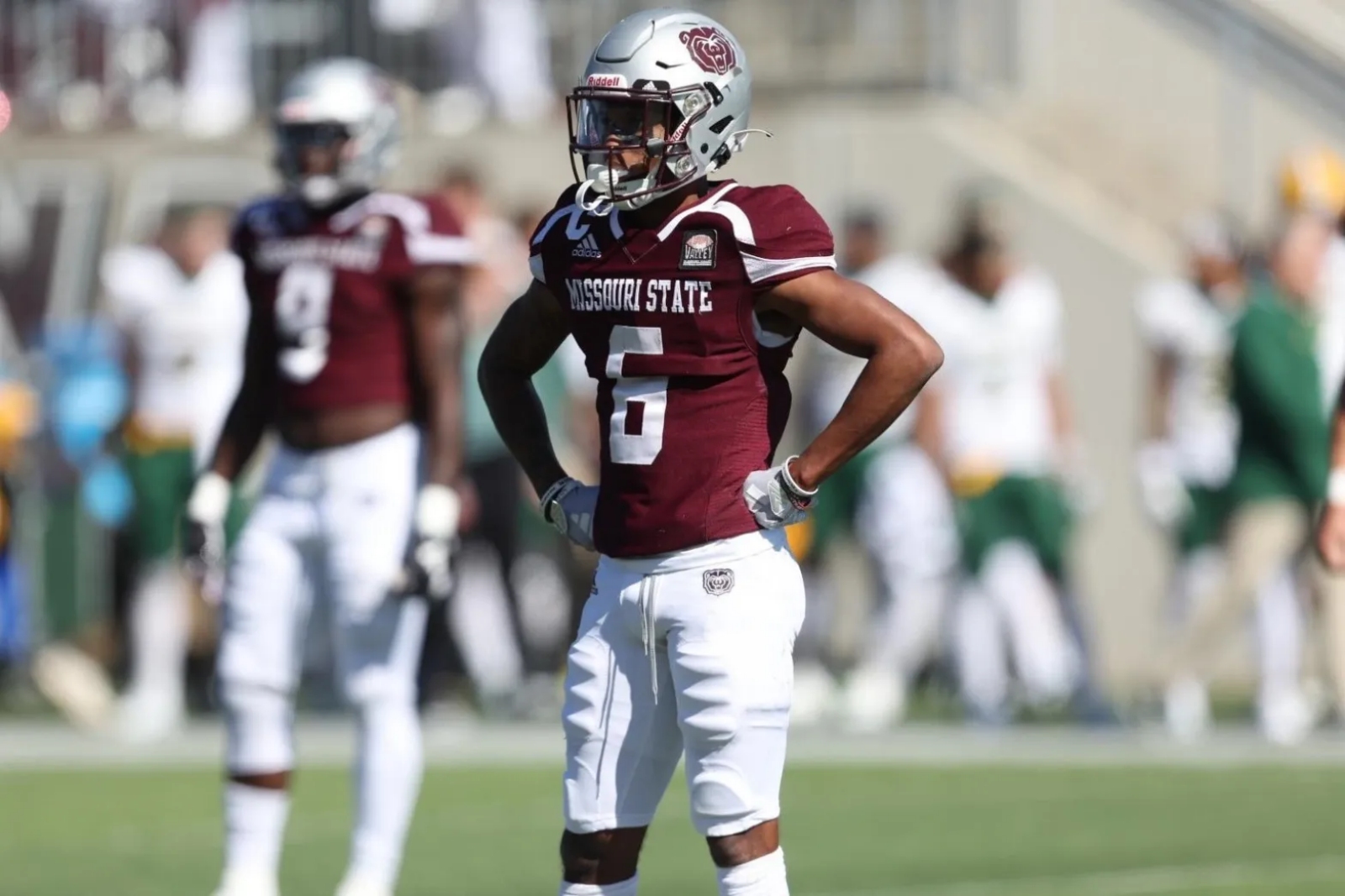 Raylen Sharpe, wearing a Missouri State football uniform, looks toward the sidelines during a game