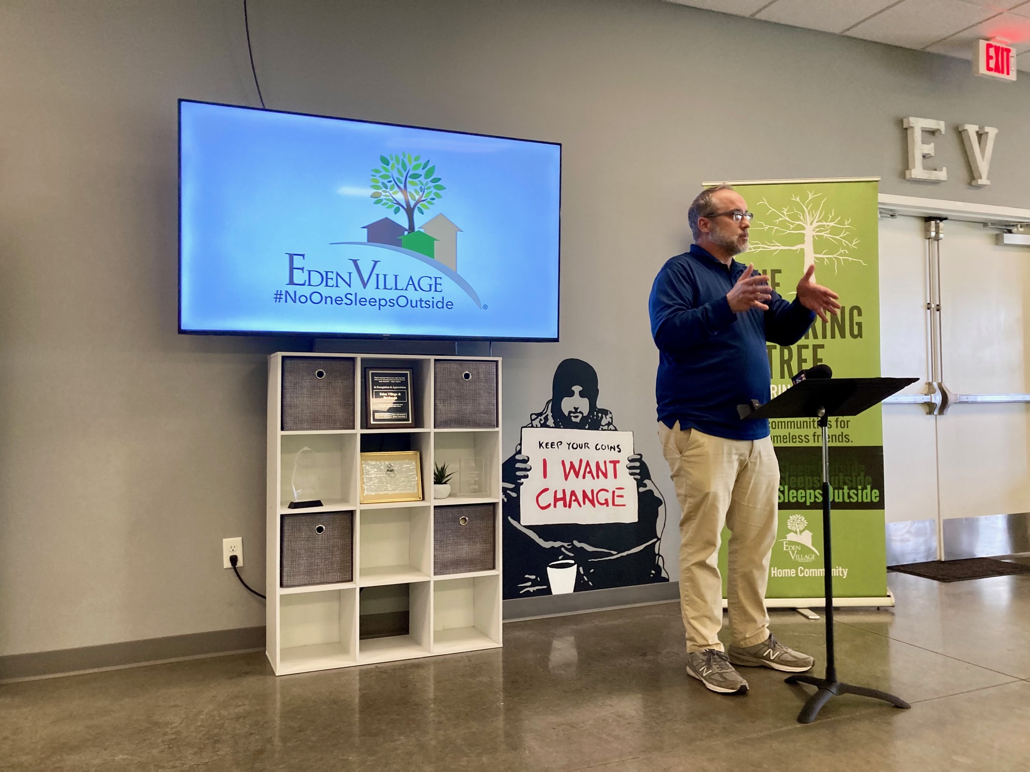 Nate Schlueter, chief visionary officer for Eden Village, speaks at a press conference