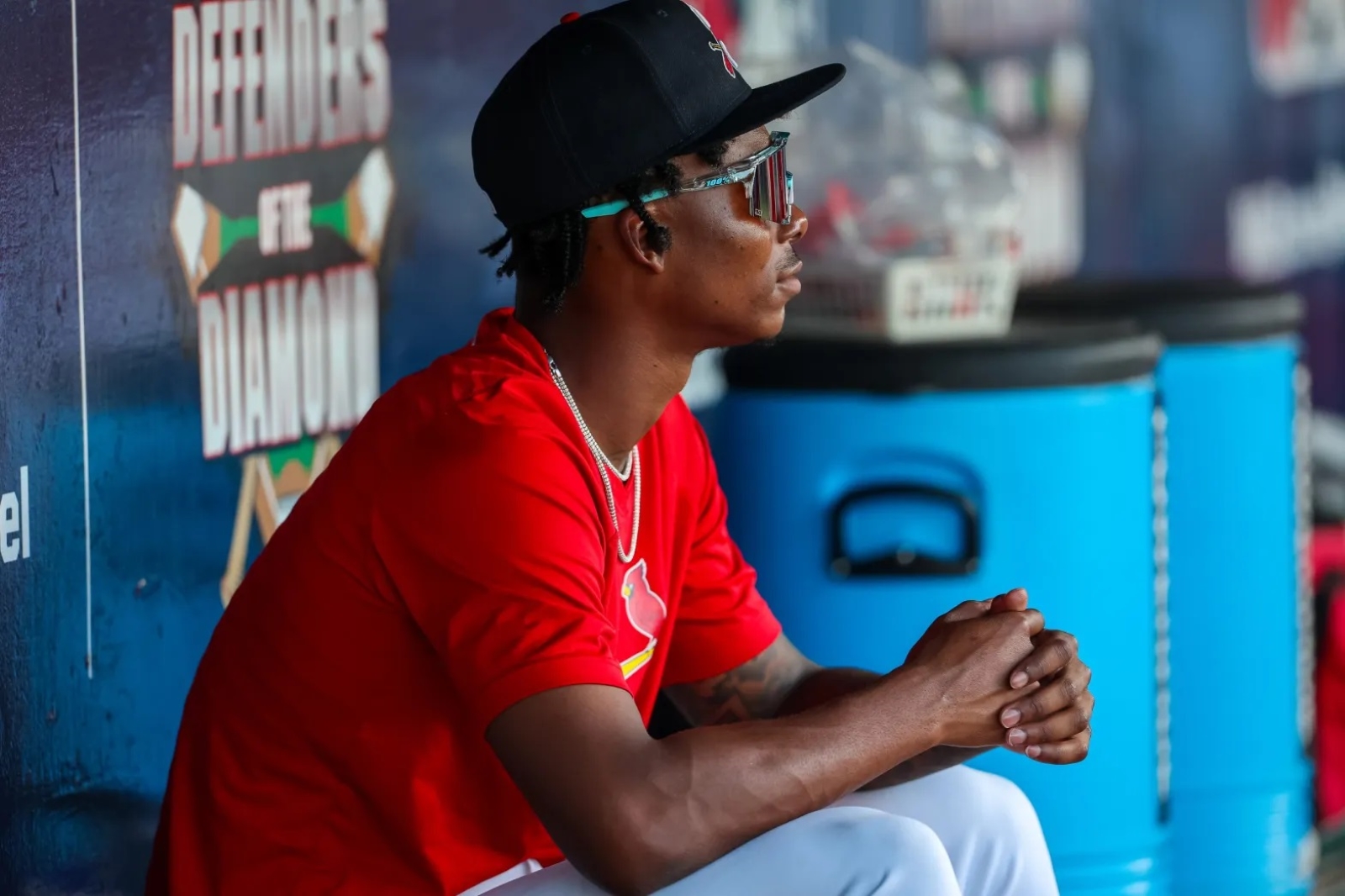 Tink Hence, wearing a Springfield Cardinals uniform, sits in the dugout at Hammons Field in Springfield, Missouri.