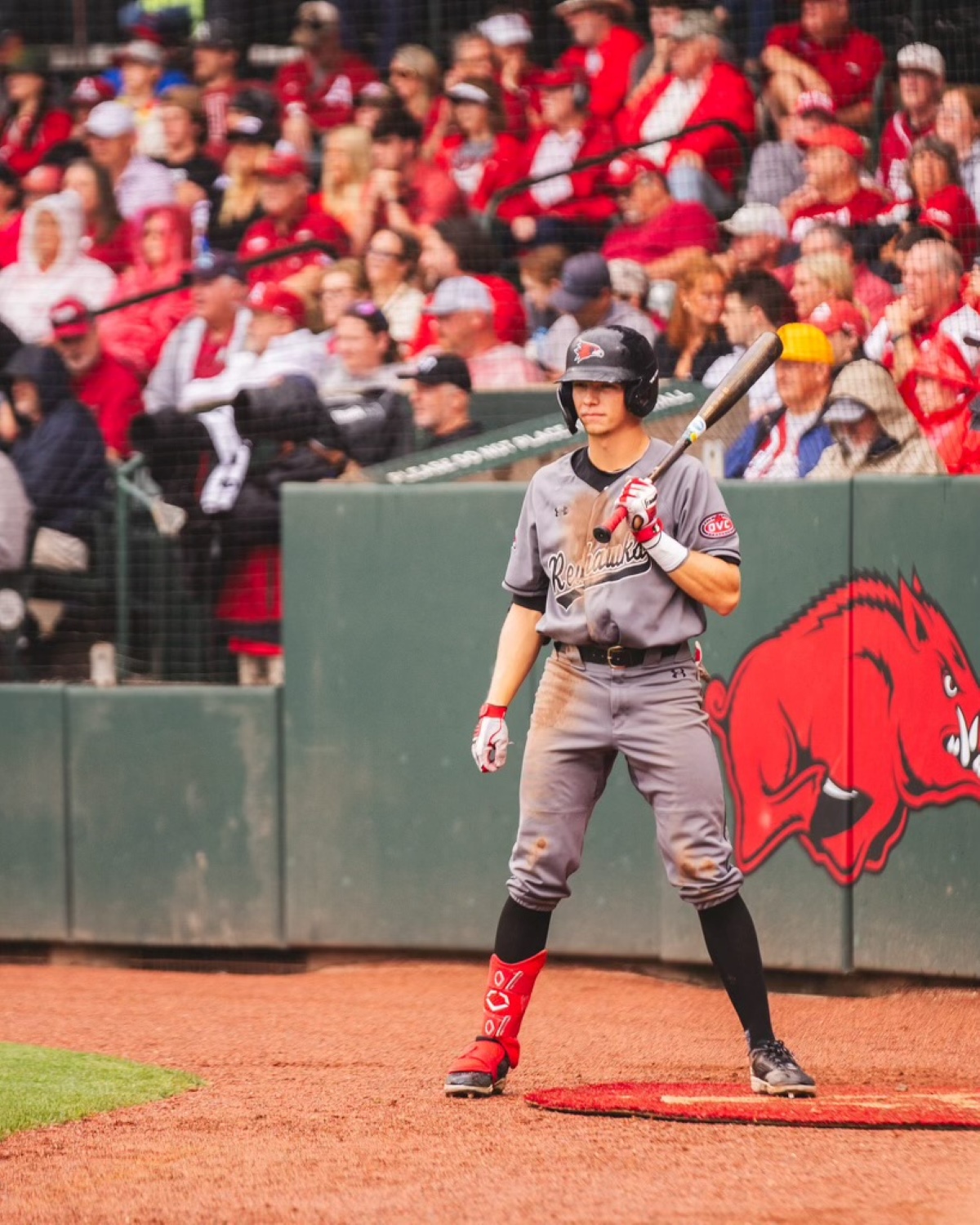 Brooks Kettering, wearing a Southeast Missouri State University baseball uniform, stands in the on-deck circle during a game at Baum-Walker Stadium in Fayetteville, Arkansas.