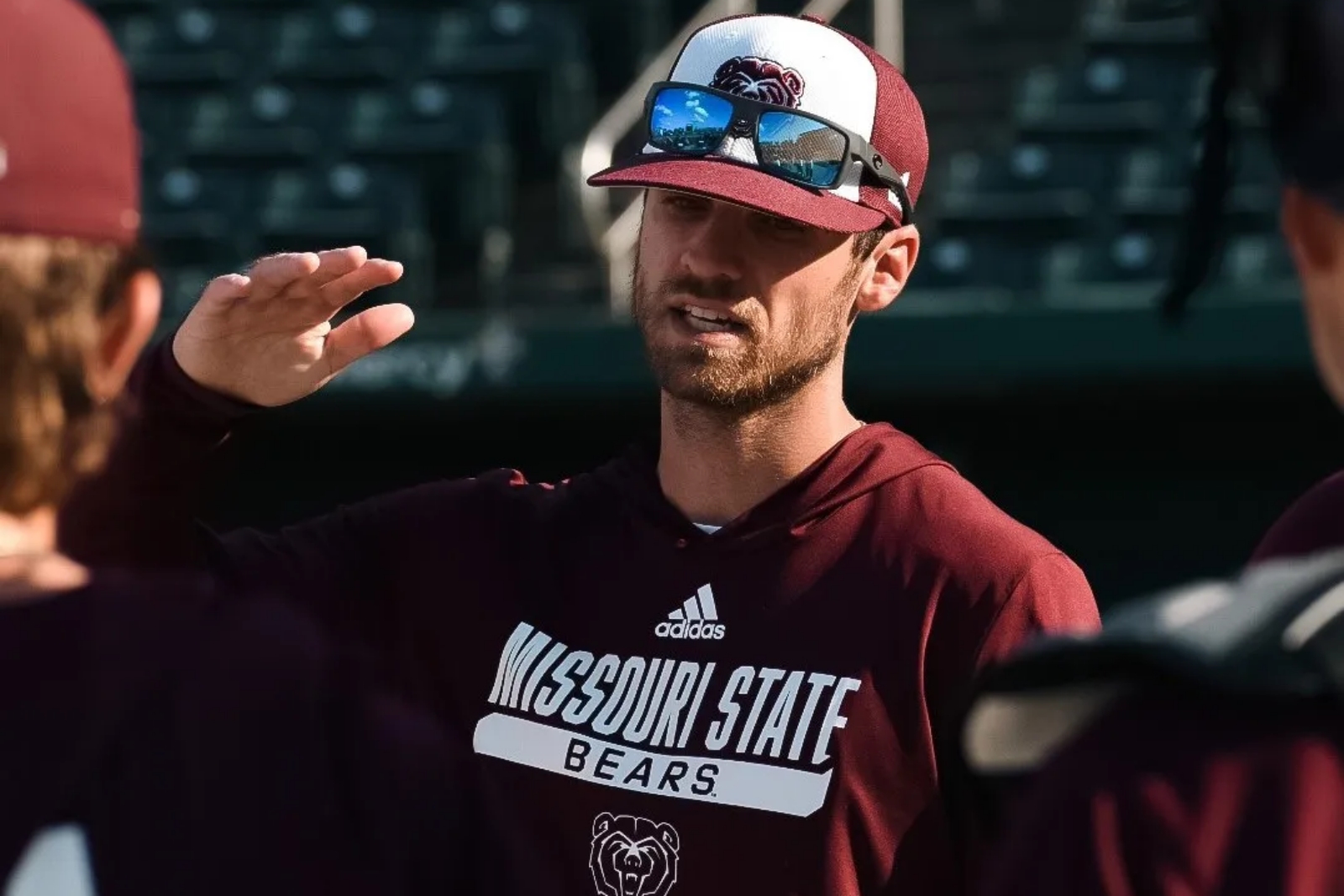 Missouri State baseball coach Joey Hawkins gives instructions to his players before a game at Hammons Field in Springfield, Missouri.