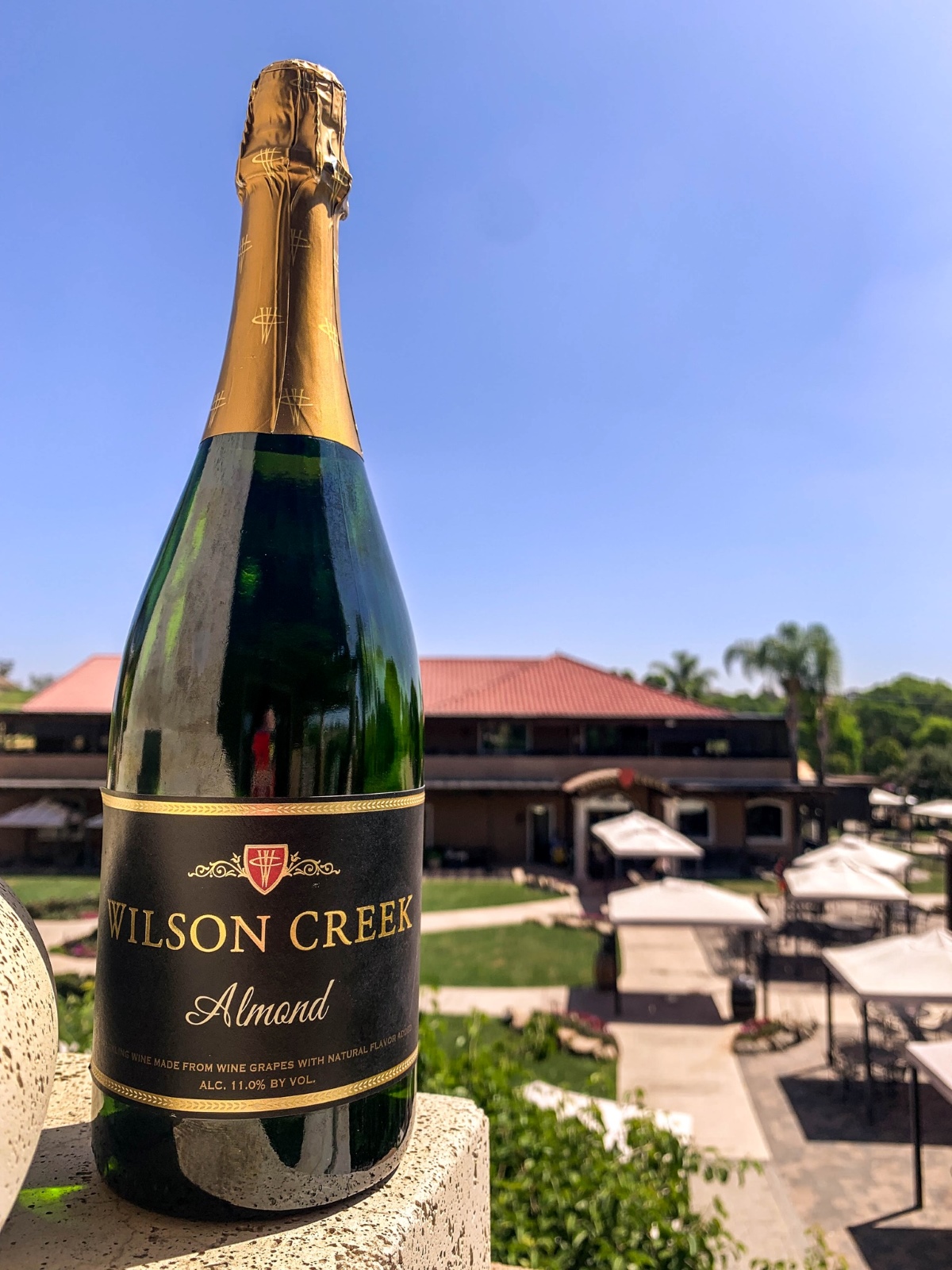 A bottle of Wilson Creek Winery's Almond Sparkling Wine sits on a ledge outside the winery in California.