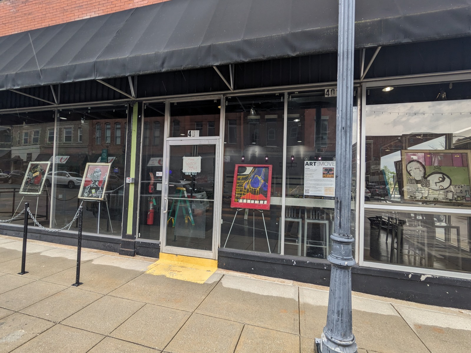 Art by William Wallace is displayed in the windows of the Wheelers Lofts building in downtown Springfield, Missouri.