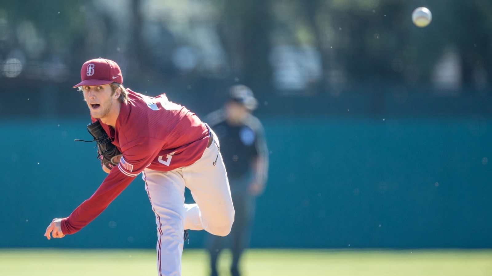 Quinn Mathews, wearing a Stanford Cardinal uniform, pitches the baseball during a game
